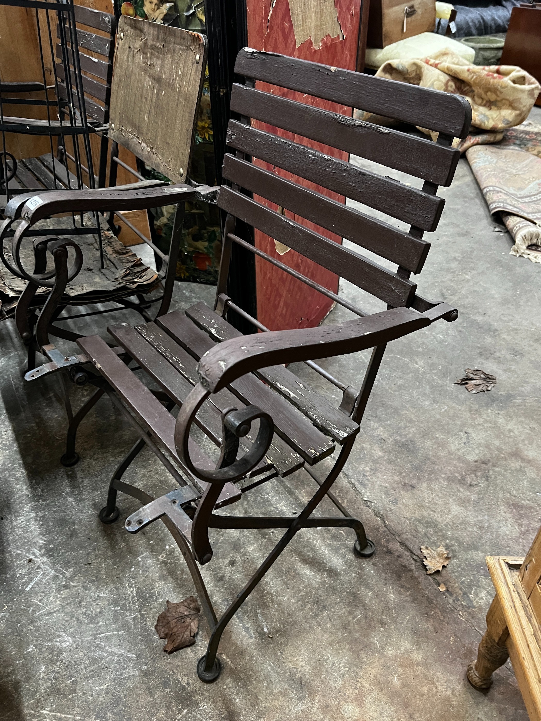 A wrought iron garden growing frame, height 130cm together with three wrought iron folding garden chairs
